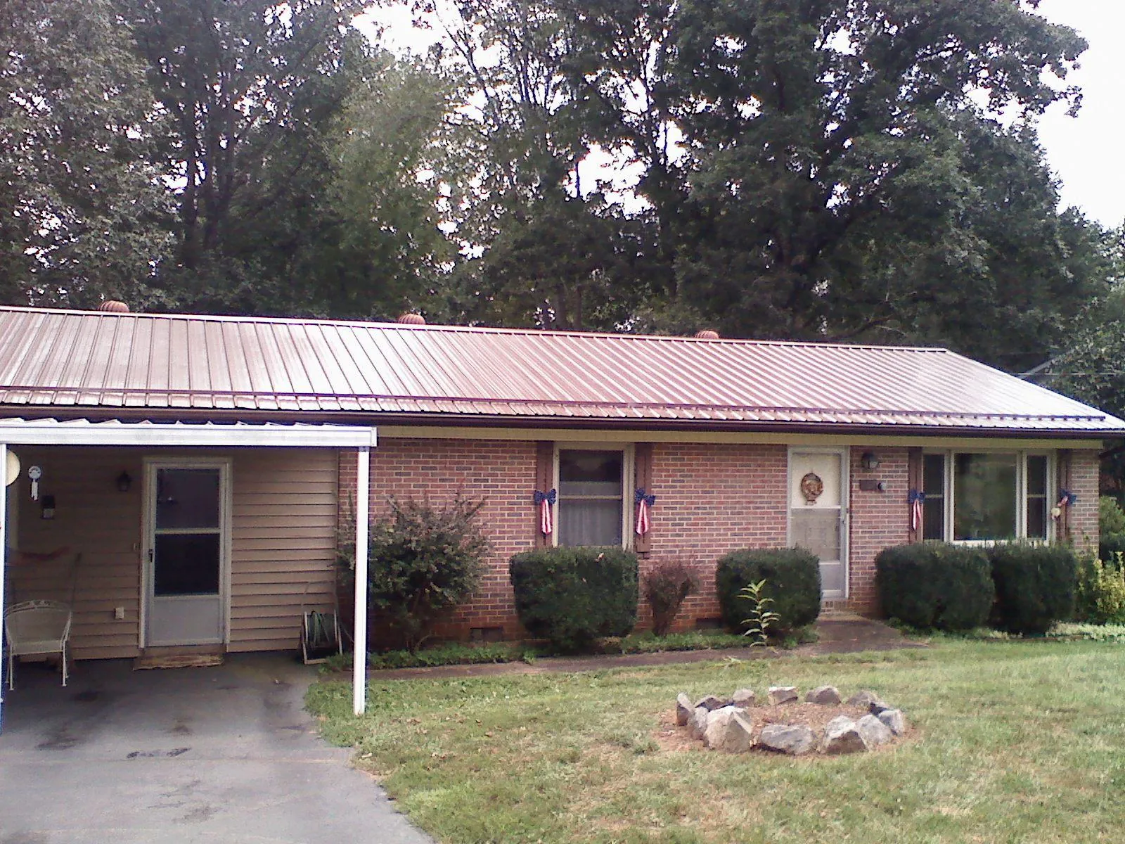 Bronze metal roof and carport on a brick ranch home — Roof Repair work by our crew in Santa Barbara